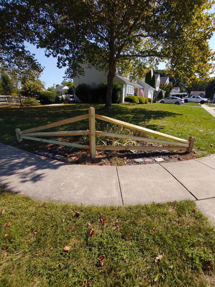 Small split-rail fence in a V in a front yard